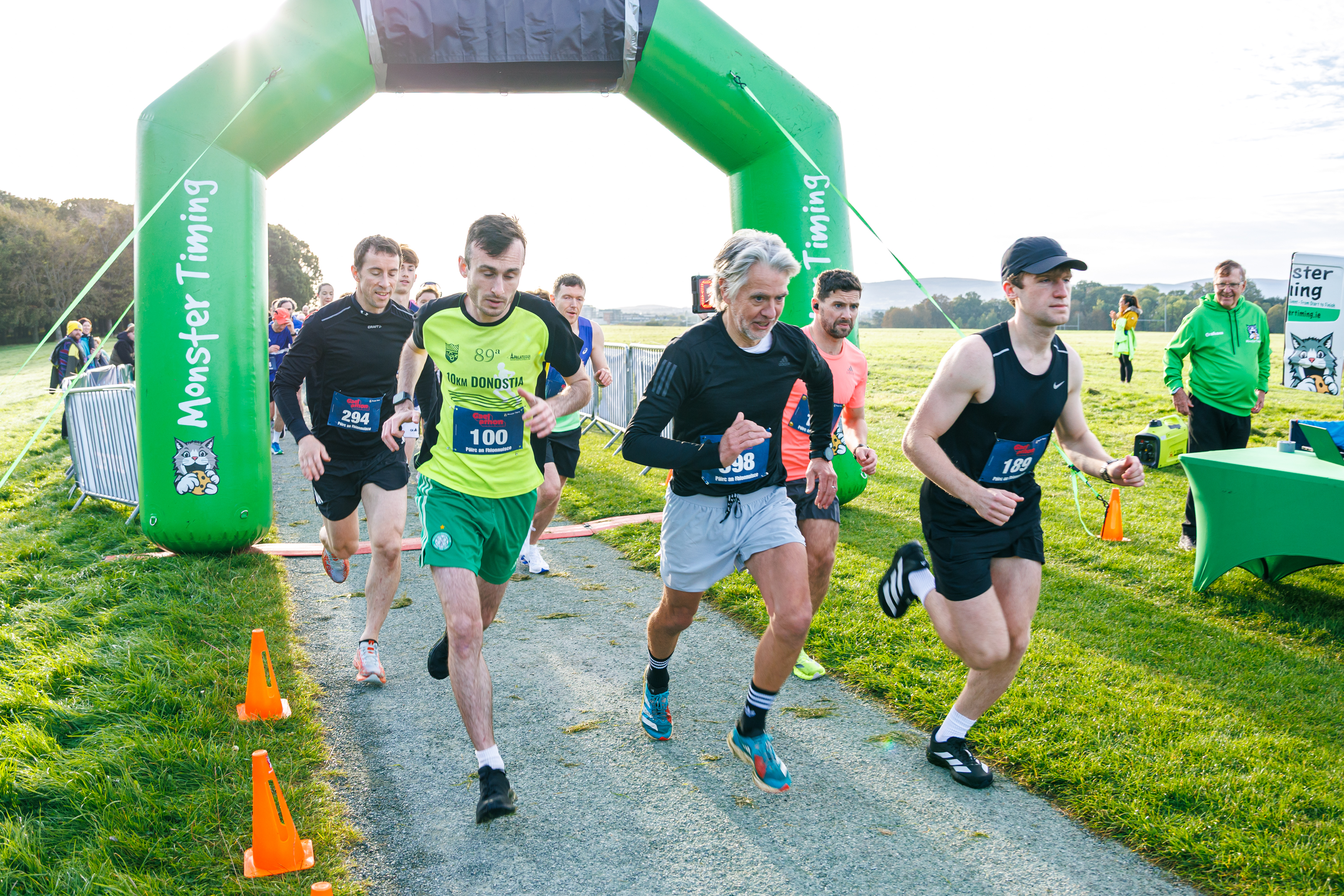Runners pass beneath the Monster Timing arch at Gaelathon in Phoenix Park